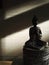 Buddhism. Silver Buddha at sunset.