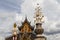 Buddhist background with amazing cloudy sky, buddhist statue, traditional temple and golden flower