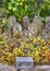 Buddhist censer and stones sculptures of Buddhas in Tamonji temple at autumn.