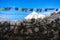 Buddhist flags on a stone fence in the himalayan mountains, Nepal