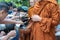 On buddhist holy day Thai buddhist people always go to temple to offer food to monks