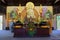The Buddhist monk at an altar with the sitting Buddha in one of pagodas of Thien Vien Truc Lam Monastery. Vietnam, Dalat