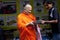Buddhist monk in Bangkok buying second hand radio