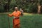 Buddhist monk with a bird on his hand in the forest