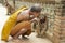 Buddhist monk kisses indochinese baby tiger in Saiyok, Thailand.