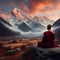 Buddhist monk meditates against the backdrop of snow-capped mountains