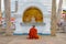 Buddhist monk meditates at Buddha sculpture, Anuradhapura