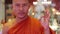 buddhist monk with orange robe pray in temple