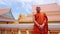 buddhist monk with orange robe pray in temple