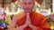 buddhist monk with orange robe pray in temple