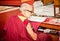 Buddhist monk is reading mantra in Bouddanath in Kathmandu