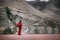 Buddhist Monk in red robe looks on Diskit Monastery, Indian Himalaya, Nubra Valley