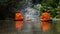 Buddhist monk in small wooden boat sailing in canal for receive food in morning, The culture tradition Buddhist monk of making