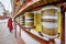 A buddhist monk tuning golden prayer wheels at the Soma Gompa in the Indiana Himalayas in Leh city.