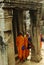 Buddhist monks in Angkor Wat, Cambodia, at pillars