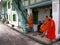 Buddhist monks converse outside their home at Wat Benchamabophit temple in Bangkok, Thailand