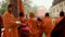 Buddhist monks entering in temple for daily pryers in line at day from flat angle