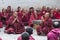 Buddhist monks put their palms together and chanting after drastic debating , Sera monastery , Tibet