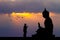 Buddhist monks at the temple at sunset