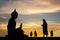 Buddhist monks at the temple at sunset