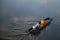 Buddhist monks travel by boat to receive alms