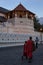 Buddhist monks walk past the Temple of the Sacred Tooth Relic in Kandy, Sri Lanka.