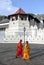 Buddhist monks walk past the Temple of the Sacred Tooth Relic in Kandy in Sri Lanka.
