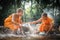 Buddhist novices are cleaning bowls and splashing water in the s