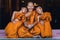Buddhist novices sitting together feeling happy and smile