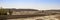 Buddhist offerings along dry riverbed in front of Mogao Grottoes