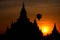 Buddhist Pagoda silhouette and balloon at sunrise. Bagan, Myanmar