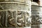 Buddhist prayer spinning drums with ancient mantras close up. Fixture for traditionhal Buddist prayer