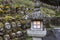 Buddhist rakan stone statues and a stone lantern at the Otagi Nenbutsu-ji temple in Arashiyama, Kyoto, Japan