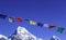 Buddhist Shrine Mountain with prayer flags over the blue sky