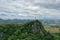 Buddhist statue rests above the mountain in Ratchaburi Thailand