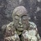 Buddhist stone relic with damaged head, covered with moss and lichen. Umiyama, Fukui Prefecture, Japan