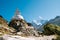 Buddhist Stupa - architectural and religious structure with Ama Dablam 6814m peak covered with snow and ice. Imja Khola valley in