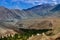 Buddhist Stupa, mound-like or hemispherical structure containing relics , used as a place of meditation. Green trees and Himalayan