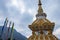 Buddhist stupa with religious pryer flags and cloudy sky at morning from low angle