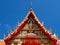 Buddhist temple gable soars into blue sky