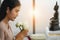 Buddhist woman holding lotus flowers worship to buddha statue at home