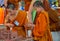 Buddhist young monk in Thailand temple wat doing hand crafts