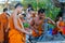 Buddhist young monks doing handcrafts in the temple yard