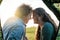 Budding romance in the great outdoors. Shot of a young couple bonding outside their tent on a camping trip.