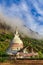 Buddist stupa with green mountains and blue sky, on the way to t