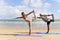 Buddy athlete woman, man doing yoga and stretching body on summer island beach, couple practicing yoga at seashore of tropical