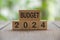 Budget 2024 text on wooded blocks with blurred nature background. Yearly concept.