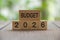 Budget 2026 text on wooded blocks with blurred nature background. Yearly budget and forecast concept.