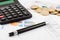 Budget spreadsheet, money, pen and calculator
