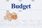 Budget your money message on a monthly calendar with coins